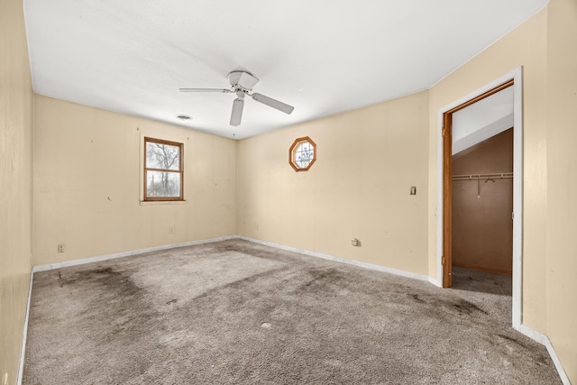 carpeted spare room with ceiling fan