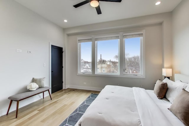 bedroom featuring ceiling fan and light hardwood / wood-style flooring