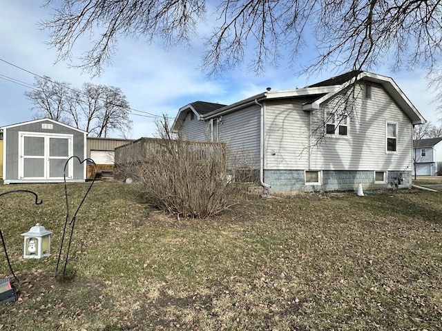 view of home's exterior with a yard and a shed