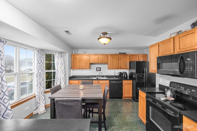 406 Walden Ct, Romeoville, IL 60446 - kitchen featuring black appliances, visible vents, dark countertops, and a sink