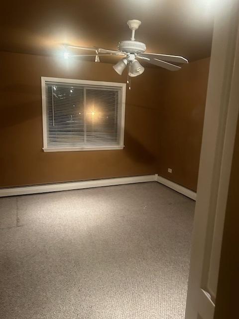 bedroom featuring rail lighting and light carpet