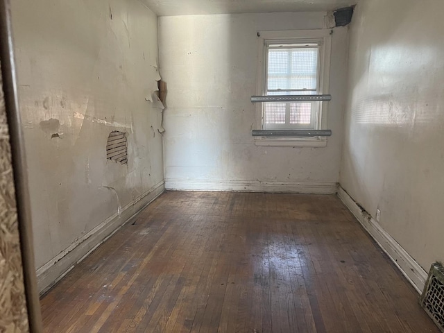 spare room featuring visible vents and hardwood / wood-style floors