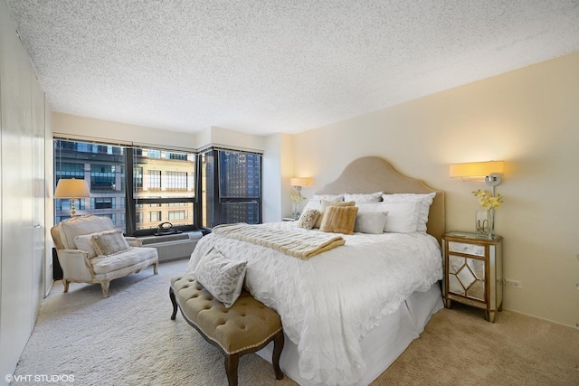 carpeted bedroom featuring a textured ceiling