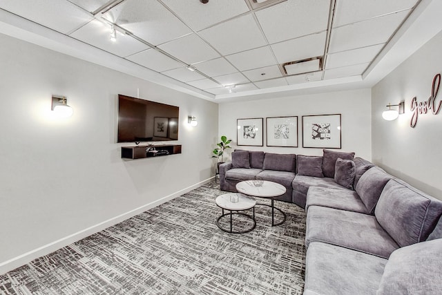 living room with carpet flooring, a drop ceiling, and rail lighting