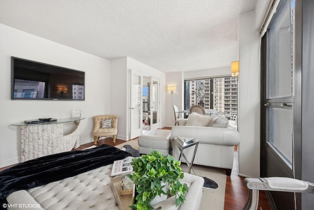 living room with hardwood / wood-style flooring and a textured ceiling