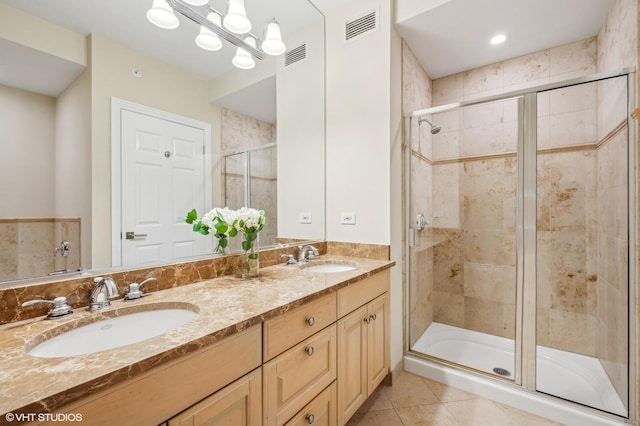 bathroom with vanity, a shower with door, tile patterned floors, and a chandelier