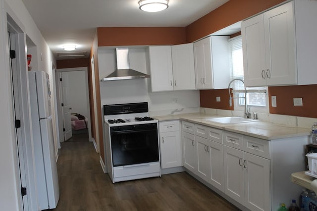 17544 Roy St, Lansing, IL 60438 - kitchen with gas range, white cabinetry, wall chimney exhaust hood, and sink