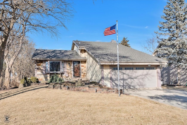 view of front of house featuring a garage and a front lawn