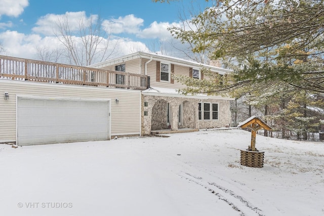 view of front of house featuring an attached garage and a balcony