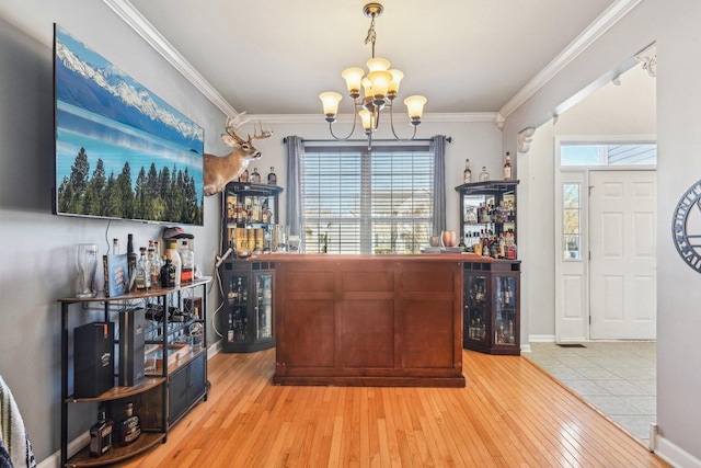 bar featuring wine cooler, crown molding, and light hardwood / wood-style flooring