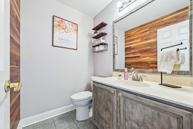 bathroom with tile patterned floors, toilet, vanity, and wood walls