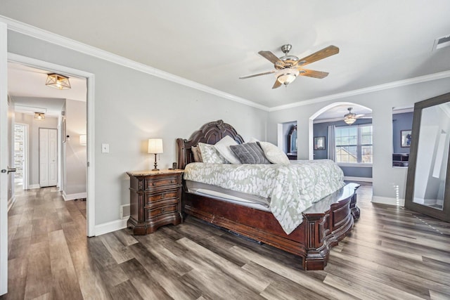 bedroom with hardwood / wood-style flooring, ceiling fan, and ornamental molding