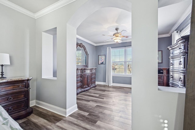 interior space featuring ceiling fan, ornamental molding, and hardwood / wood-style floors