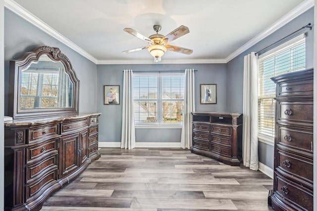 interior space with ornamental molding, light hardwood / wood-style floors, and ceiling fan