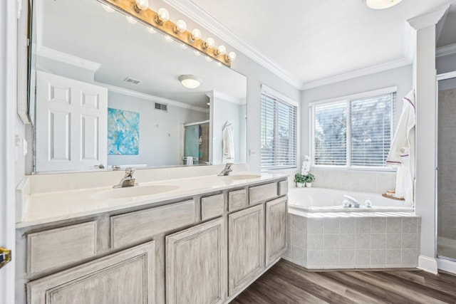 bathroom with hardwood / wood-style flooring, ornamental molding, independent shower and bath, and vanity