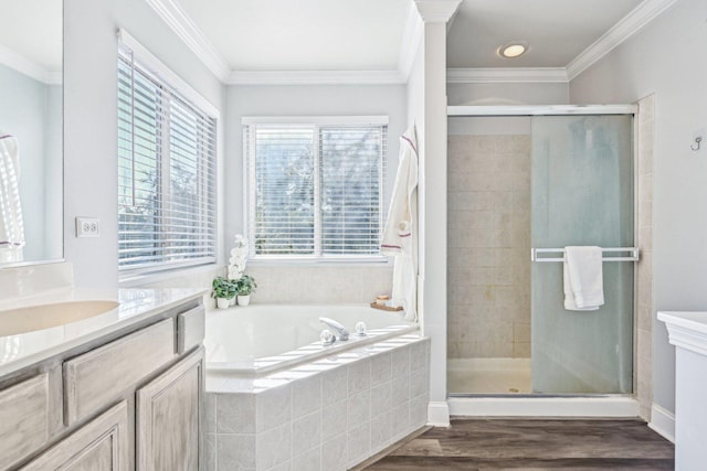 bathroom with hardwood / wood-style flooring, ornamental molding, vanity, and plus walk in shower