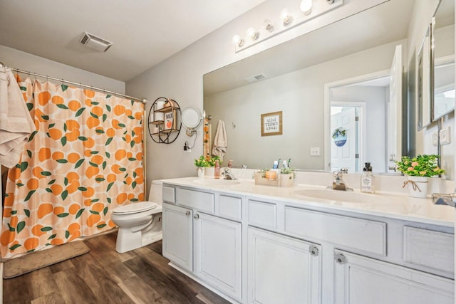 bathroom featuring vanity, hardwood / wood-style floors, toilet, and a shower with shower curtain