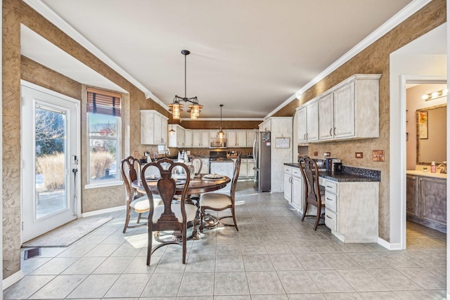 dining area featuring light tile patterned floors, ornamental molding, and sink