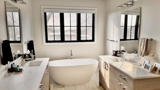 full bath with a freestanding tub and vanity