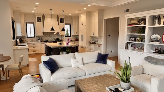 living room with recessed lighting, visible vents, and light wood-style flooring