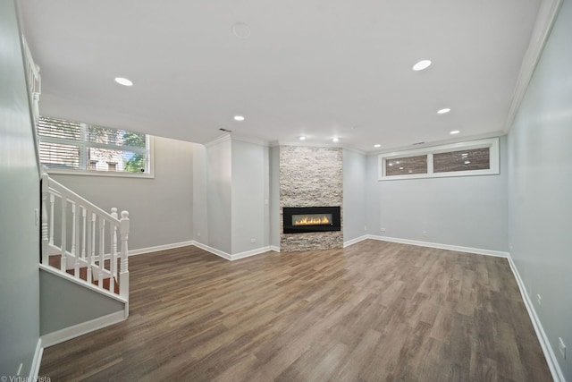 unfurnished living room with crown molding, wood-type flooring, and a fireplace