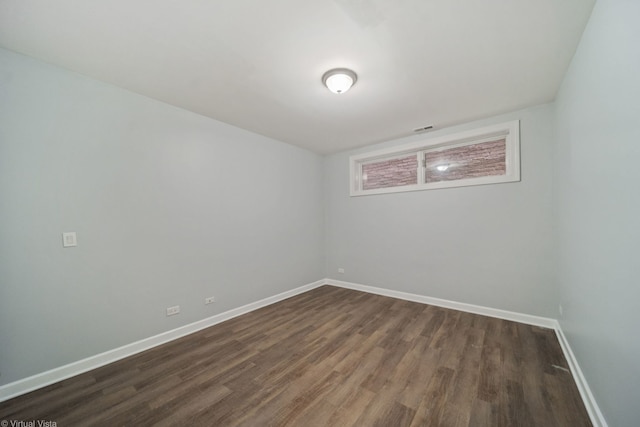 unfurnished room featuring dark wood-type flooring