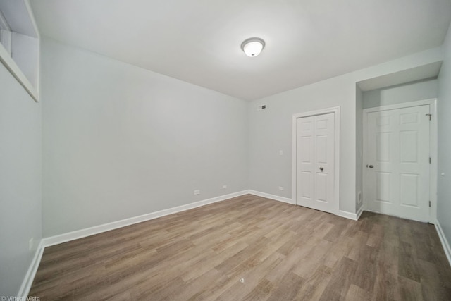 unfurnished bedroom with hardwood / wood-style floors