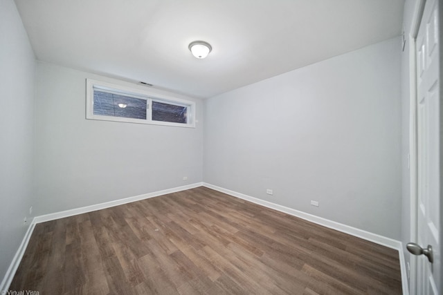 spare room with hardwood / wood-style flooring