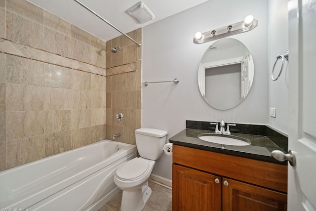 full bathroom featuring tiled shower / bath, vanity, and toilet