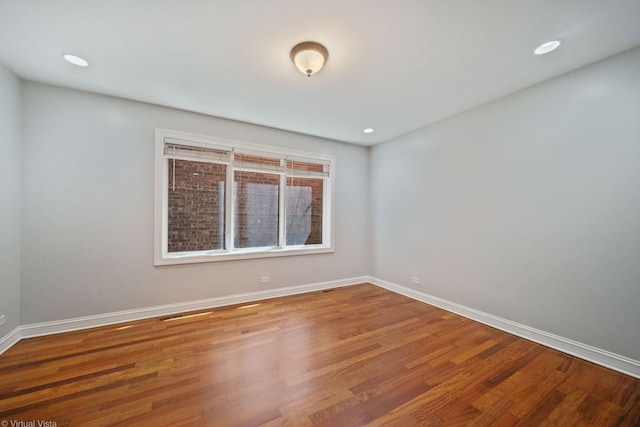 empty room with hardwood / wood-style flooring