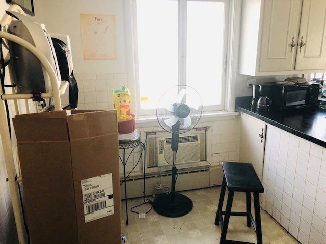 kitchen featuring a wall mounted air conditioner and tile walls