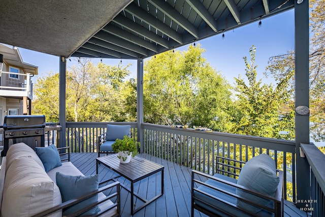 wooden deck featuring a grill and an outdoor hangout area