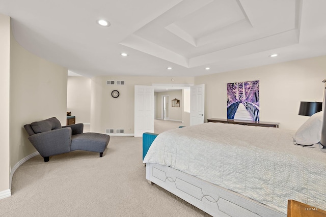 carpeted bedroom featuring a raised ceiling