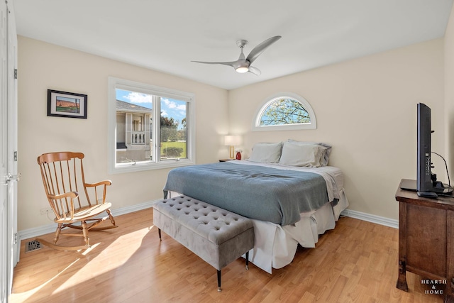 bedroom with ceiling fan and light hardwood / wood-style floors