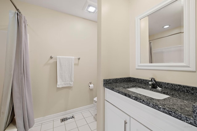 bathroom with vanity, tile patterned floors, and toilet