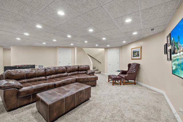 living room with light carpet and a drop ceiling