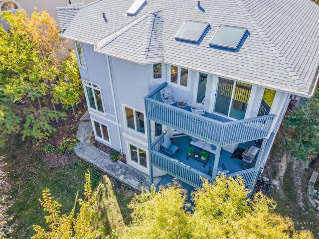 rear view of property featuring a balcony