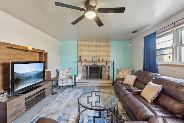 living area with visible vents, a brick fireplace, and a ceiling fan