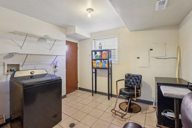 clothes washing area with visible vents, baseboards, light tile patterned floors, laundry area, and washer / clothes dryer