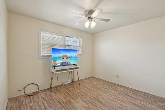 spare room featuring light wood-style flooring, baseboards, visible vents, and ceiling fan