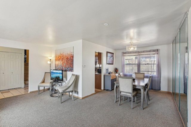 carpeted dining area featuring tile patterned flooring and baseboards