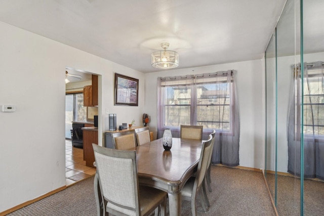 dining area with a wealth of natural light, baseboards, and light tile patterned floors