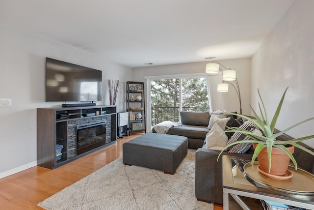 living room featuring a fireplace and light hardwood / wood-style floors