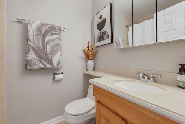 bathroom with vanity, walk in shower, and toilet