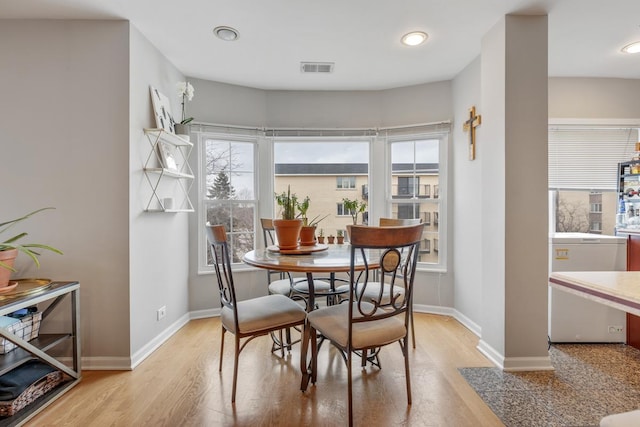 dining space featuring plenty of natural light and light wood-type flooring