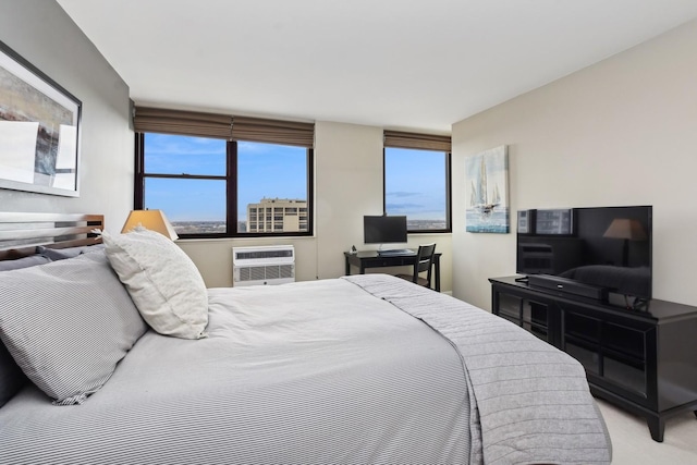 carpeted bedroom featuring an AC wall unit