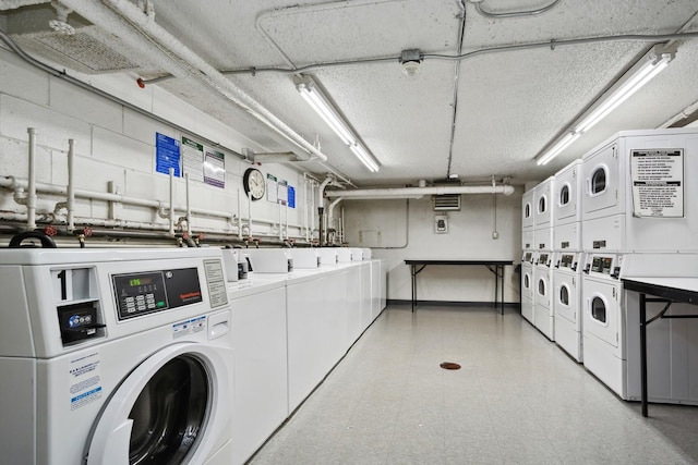 washroom featuring stacked washer / dryer and separate washer and dryer