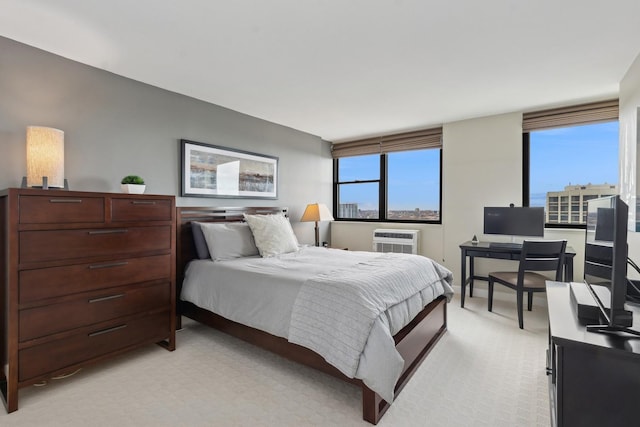 bedroom featuring light carpet and a wall unit AC