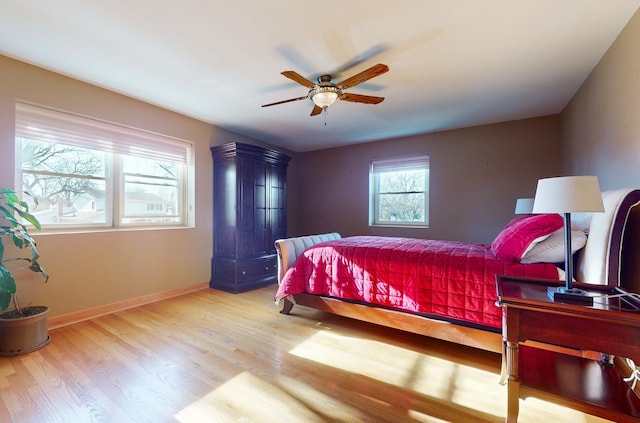 bedroom with ceiling fan and light hardwood / wood-style floors