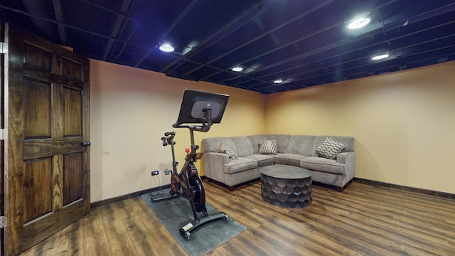 exercise room with dark wood-type flooring